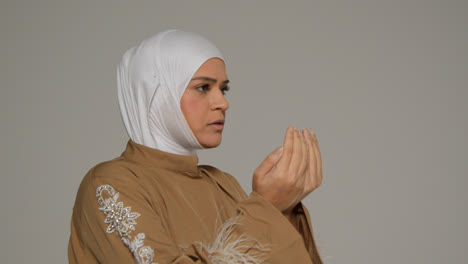 Studio-Head-And-Shoulders-Portrait-Of-Muslim-Woman-Wearing-Hijab-Praying-4